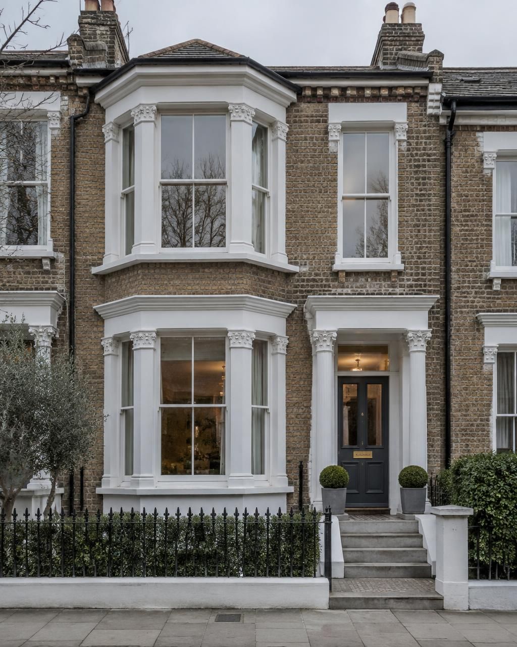 Detail close-up of a white uPVC casement window handle and multi-point locking on a British home